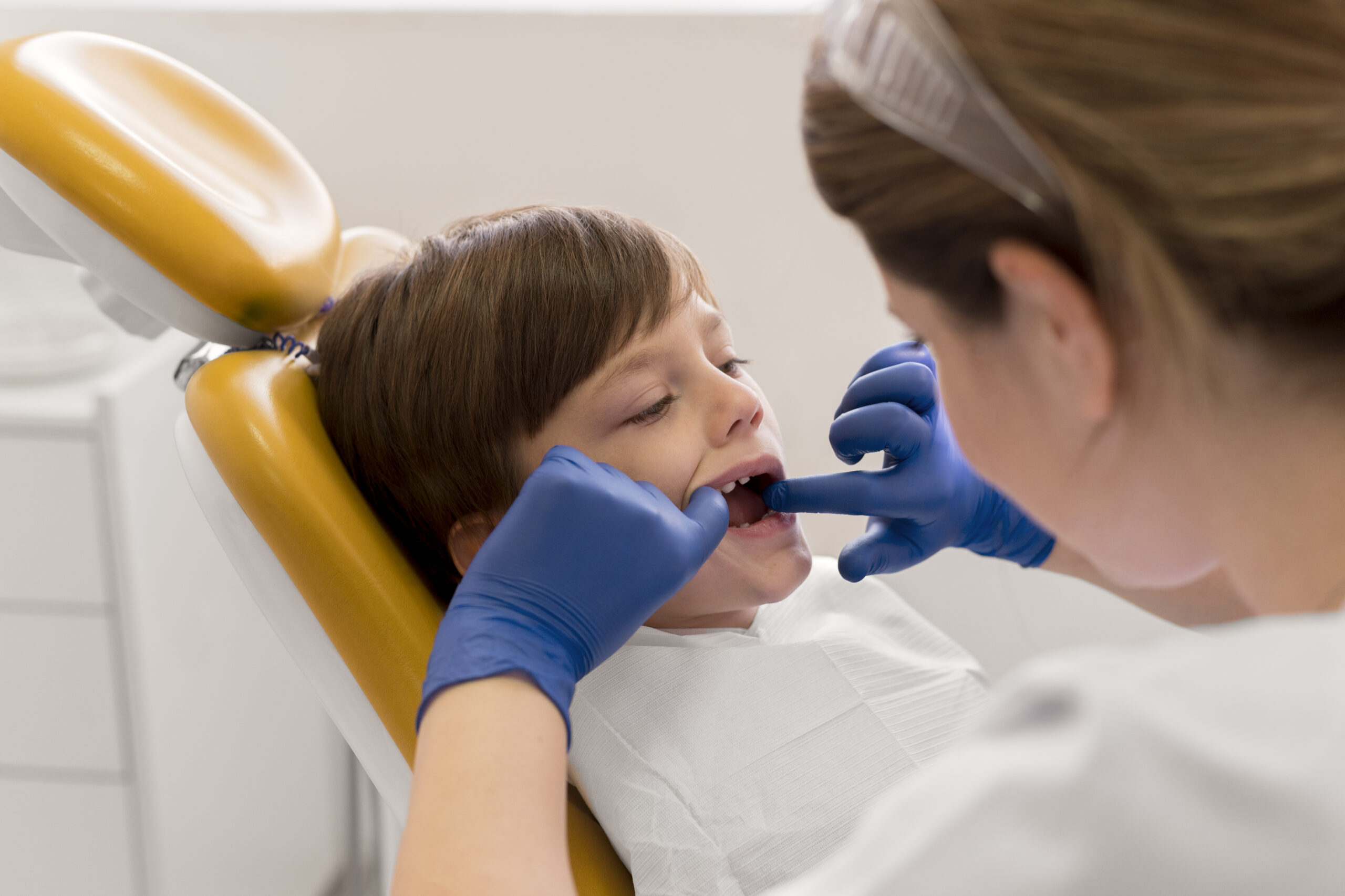 dentist cleaning child s teeth scaled