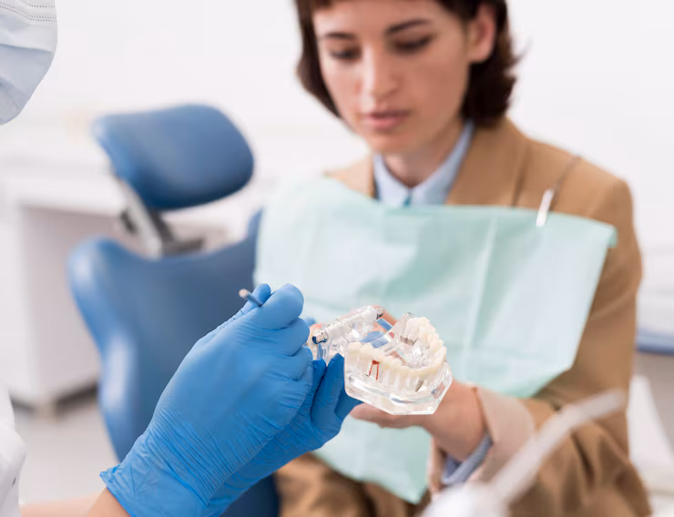female patient looking dental mold with orthodontist